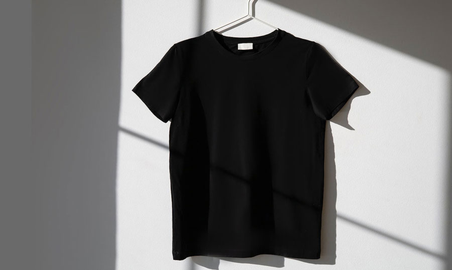 black t-shirt hangered on a wall