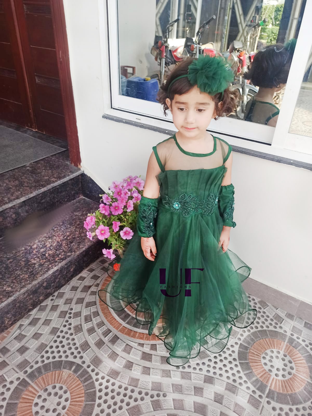 baby girl wearing green frock